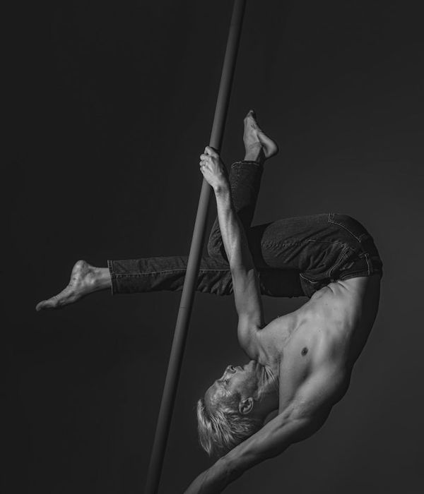 Man performing a controlled strength exercise in a minimalist gym.