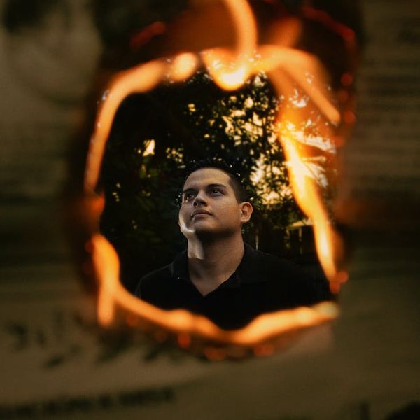 Silhouette of a man stretching against a sunrise, symbolizing energy.